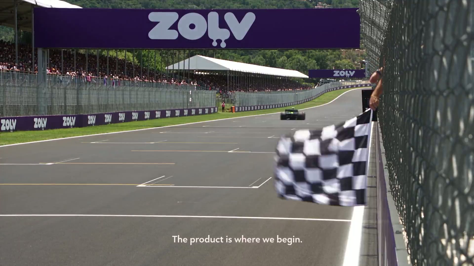 A festival main stage lit in ZOLV purple